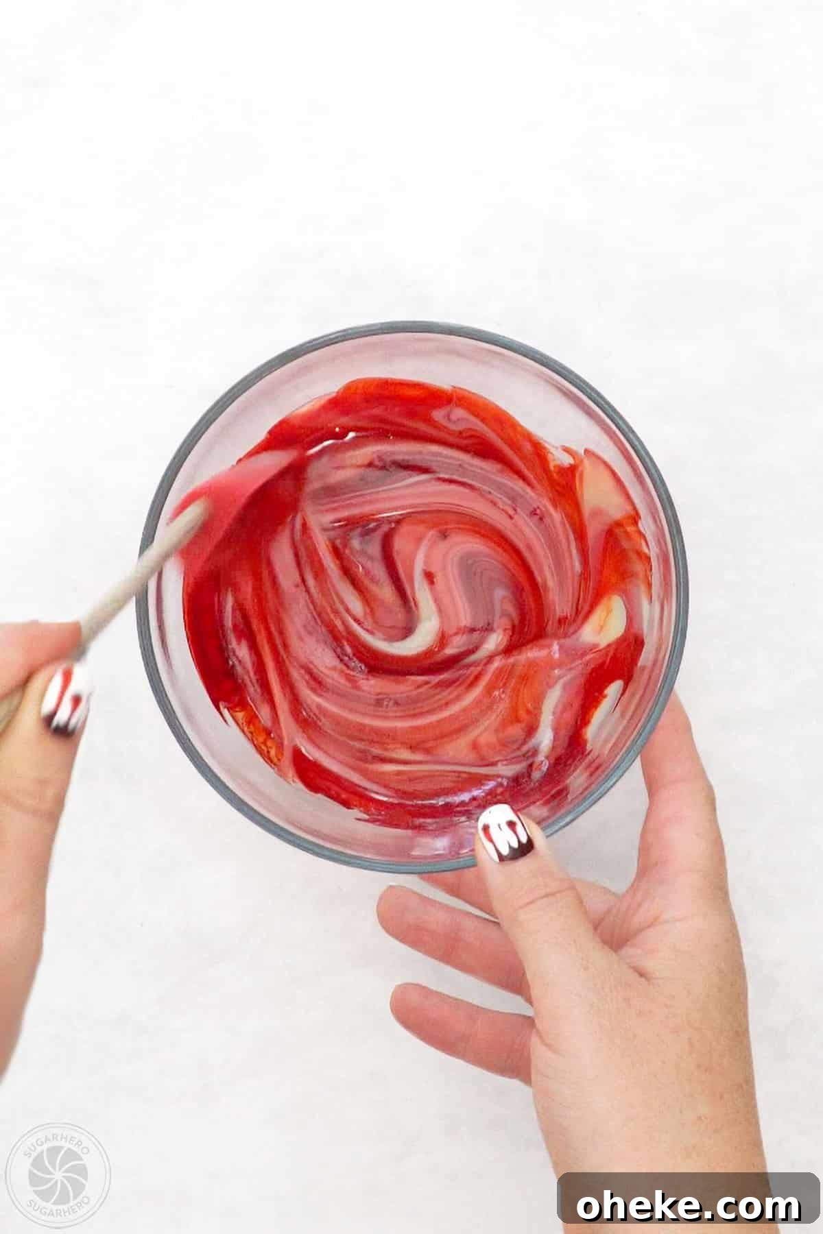Bloody Glass Cupcakes Recipe: Spooky Jello-Filled Treats for Halloween 22 Stirring red food coloring into a bowl of sweetened condensed milk.