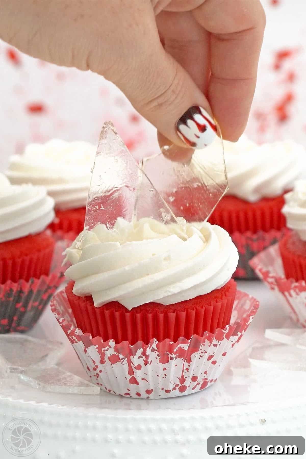 Bloody Glass Cupcakes Recipe: Spooky Jello-Filled Treats for Halloween 24 Hand placing edible sugar glass on top of a cupcake.