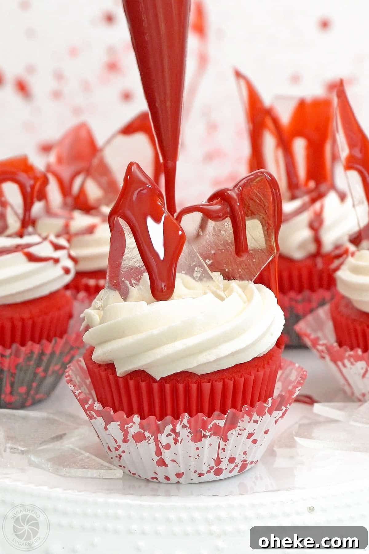 Bloody Glass Cupcakes Recipe: Spooky Jello-Filled Treats for Halloween 25 Edible blood being piped onto a bloody glass cupcake.