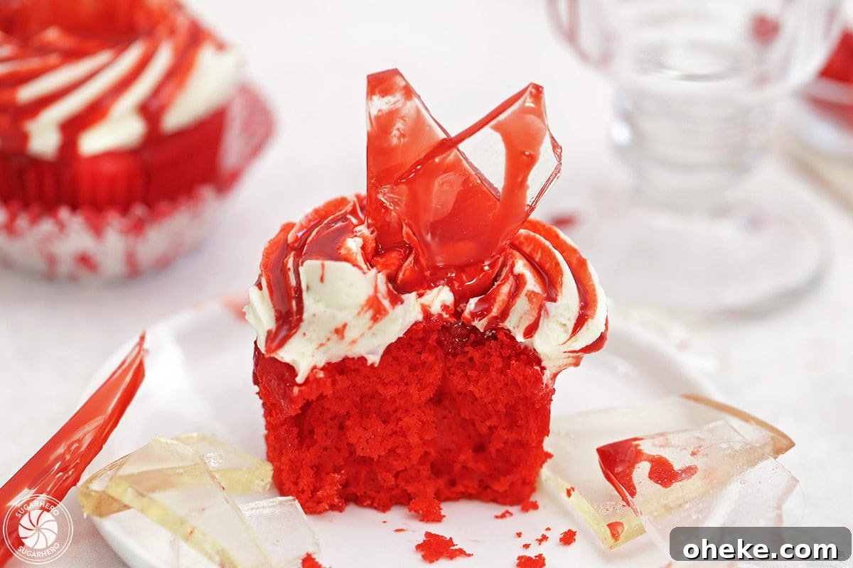 Bloody Glass Cupcakes Recipe: Spooky Jello-Filled Treats for Halloween 4 Close up of a bloody glass cupcake with a large bite removed.