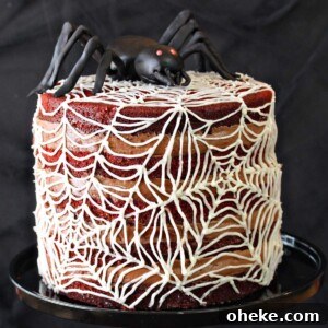 Bloody Glass Cupcakes Recipe: Spooky Jello-Filled Treats for Halloween 34 Spiderweb Naked Red Velvet Cake on a black cake stand.