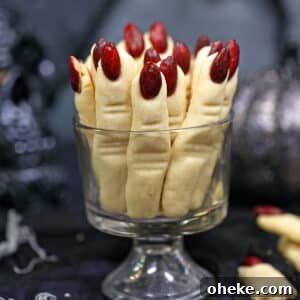 Bloody Glass Cupcakes Recipe: Spooky Jello-Filled Treats for Halloween 6 Witch Finger Cookies standing upright in a clear glass.