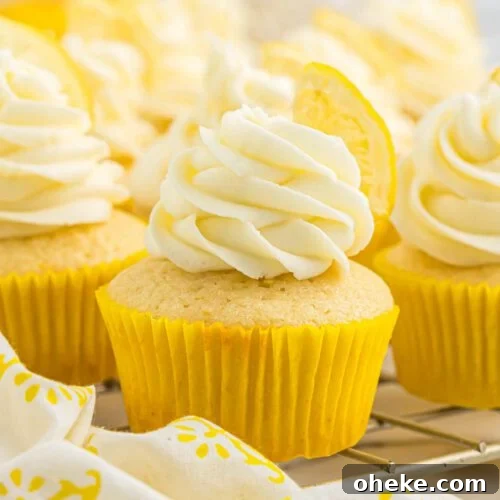 Lemon cupcakes topped with lemon slices.