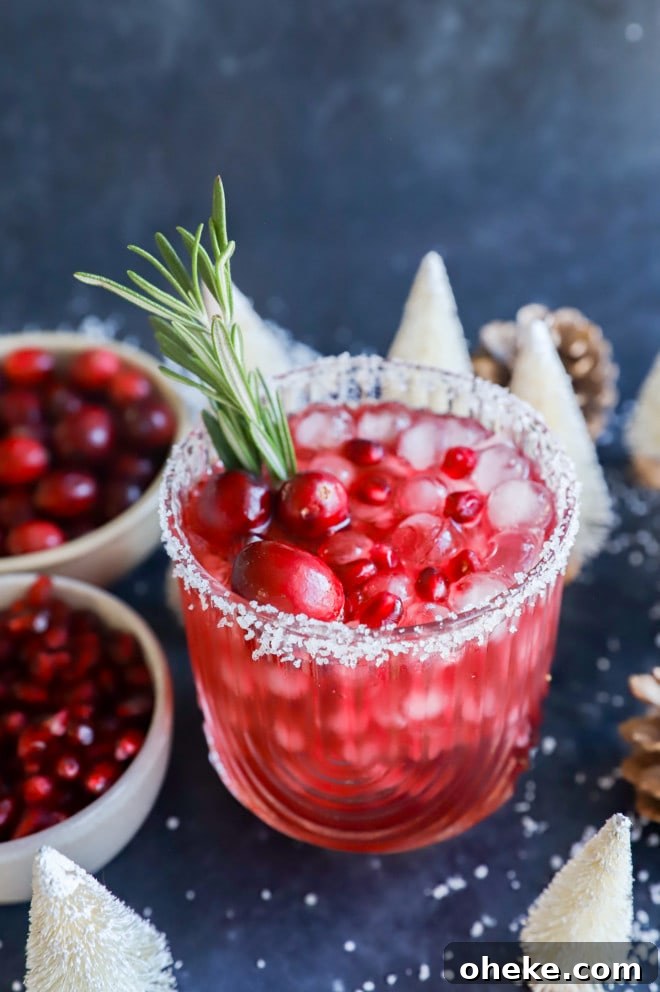 Christmas margarita in a glass with rosemary sprig