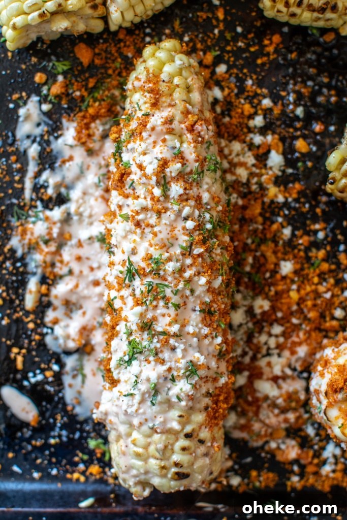 A ear of sweet corn covered in cheese
