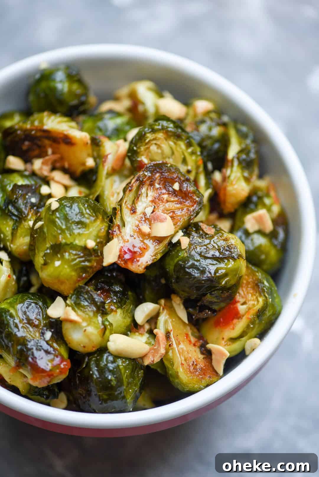 A close up of the Sweet Chili Garlic Brussels Sprouts topped with peanuts.