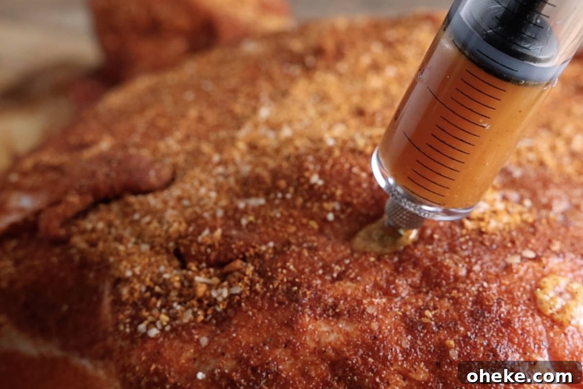 How to Inject a Pork Boston Butt for Juicy, Flavorful Results 5 Injecting pork butt with marinade.