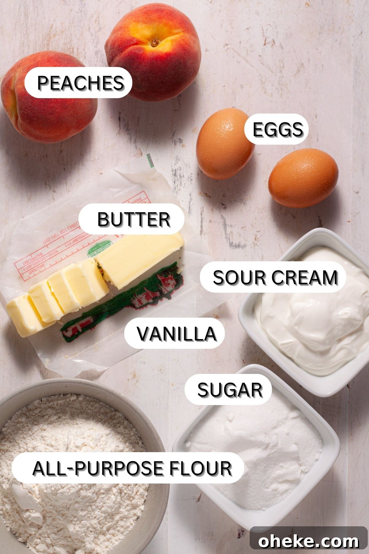 Ingredients for mini peach custard pies on a white table.