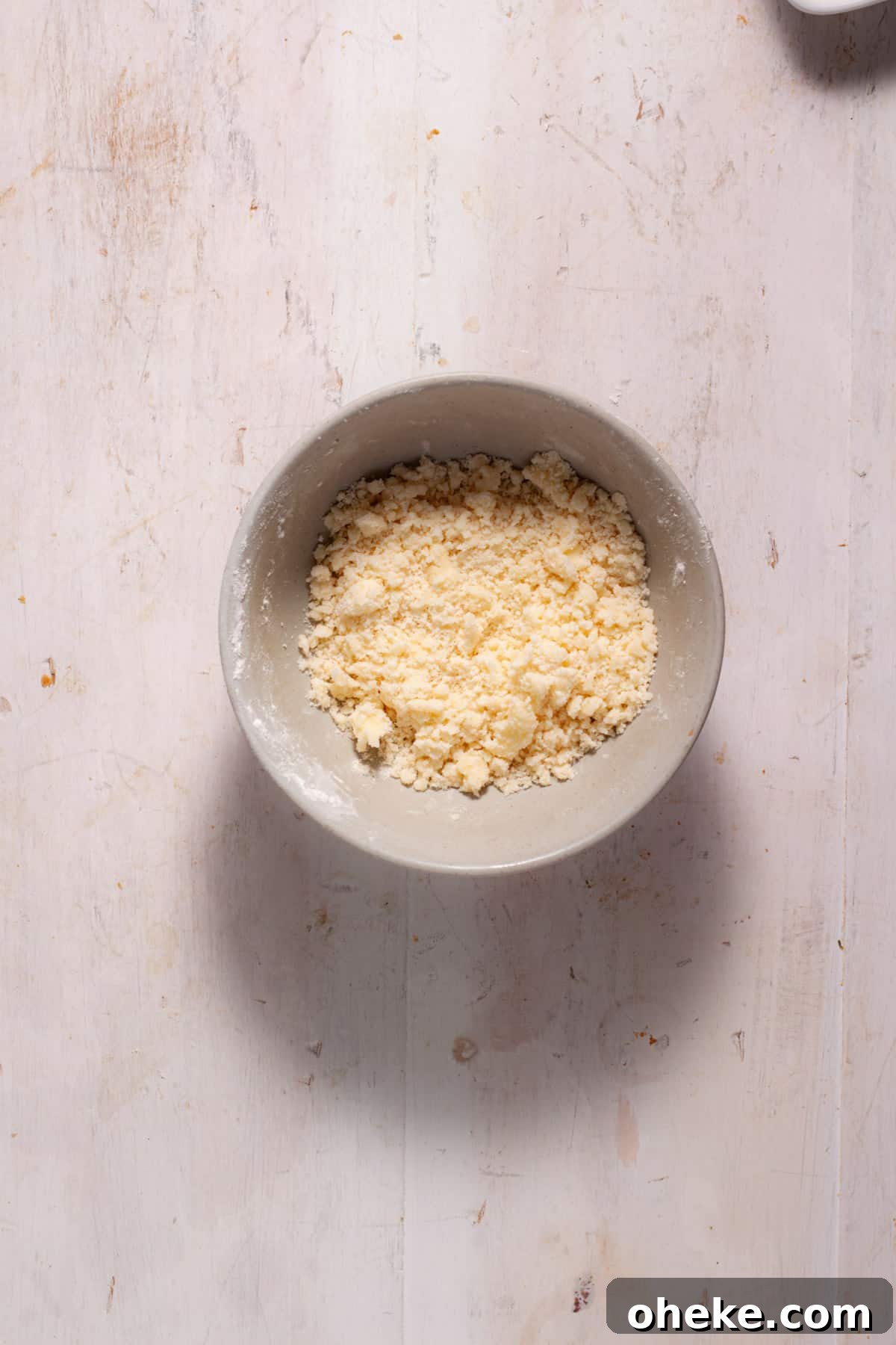 A streusel topping in a small mixing bowl.