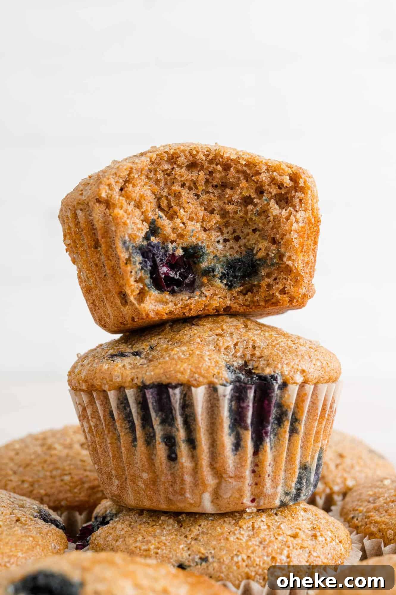 bluberry-wheat-bran-muffins-with-text Stack of blueberry bran muffins.