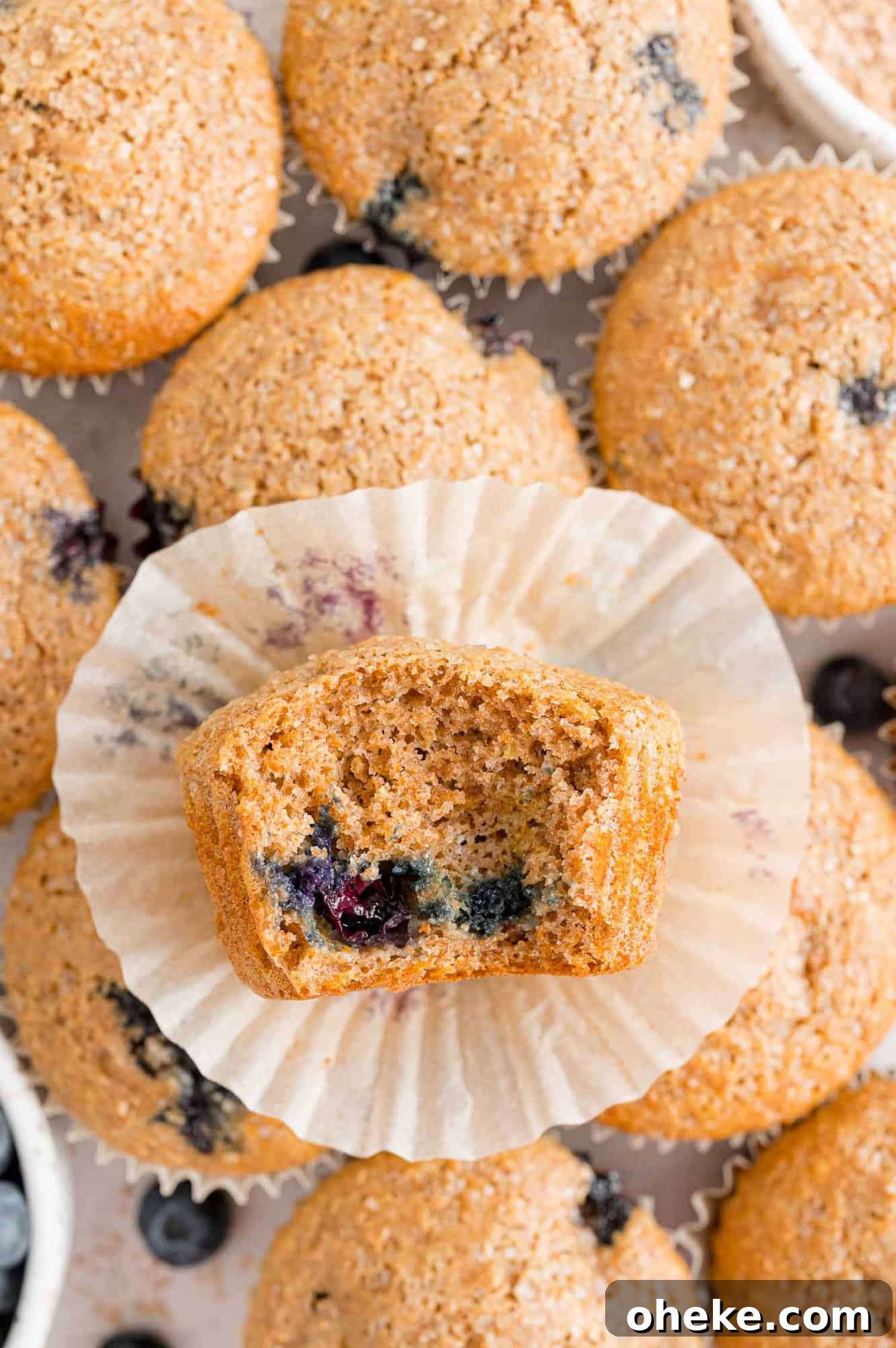 Moist Blueberry Bran Muffins with Honey and Cinnamon 11 Muffin with a bite out of it to show inside.