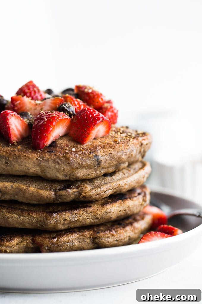 Strawberry Chocolate Chip Buckwheat Pancakes Recipe 8 Up-close side view of a stack of Strawberry Chocolate Chip Buckwheat Pancakes.