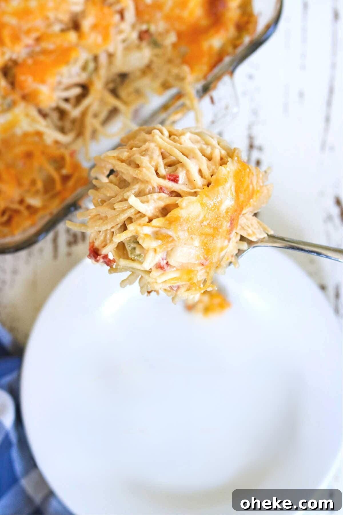 Southern Chicken Spaghetti with RoTel: Cheesy Tex-Mex Casserole 2 Rotel chicken spaghetti being served onto a white plate.
