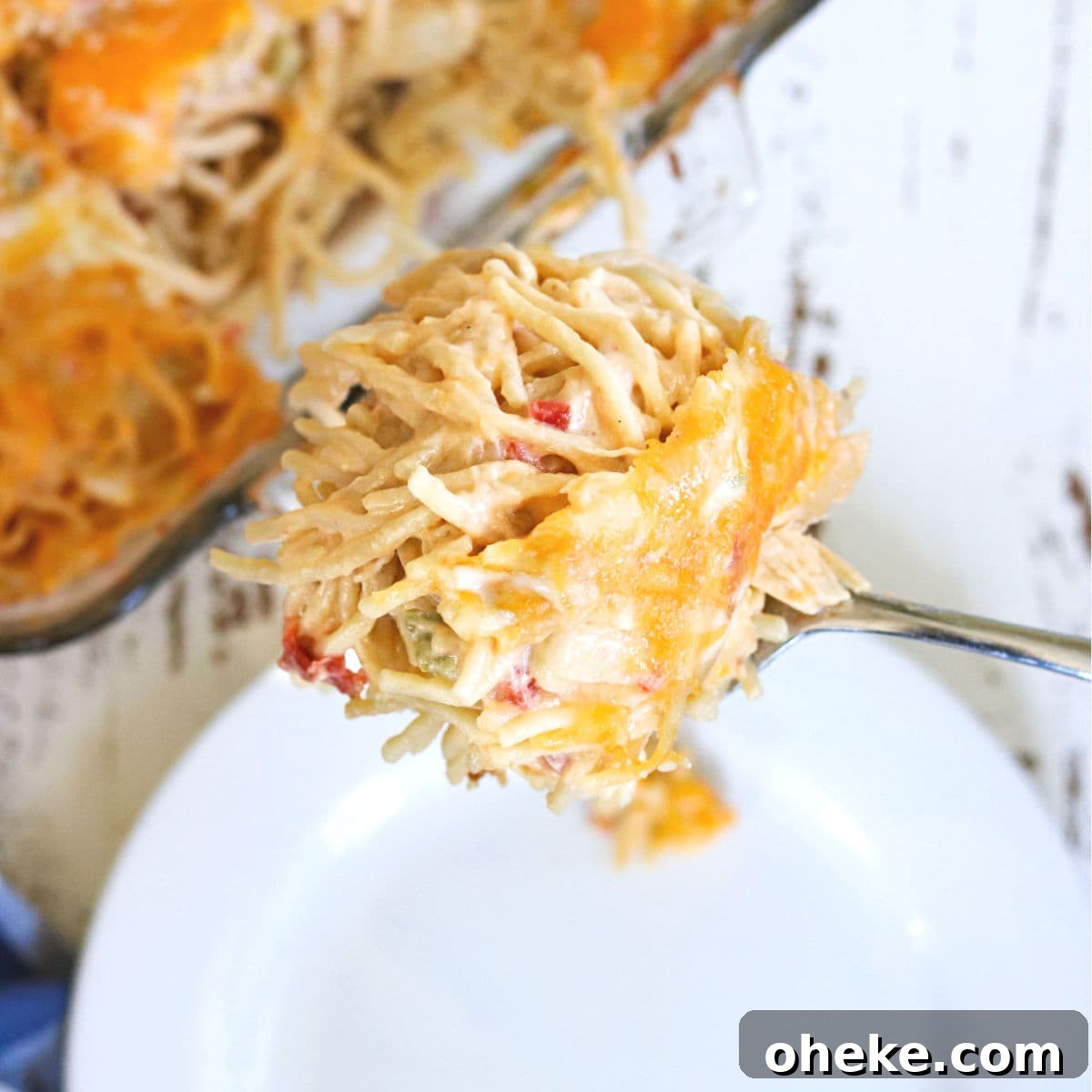 Southern Chicken Spaghetti with RoTel: Cheesy Tex-Mex Casserole 4 Serving of chicken spaghetti being placed on a plate.
