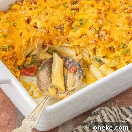Creamy pimento cheese chicken casserole with broccoli and penne pasta baked with cheddar topping.