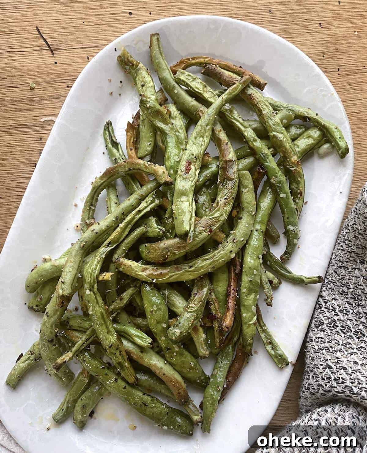 Crispy Garlic Air Fryer Green Beans_recipe 2 Crispy air fried green beans on a white plate.