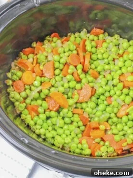 peas and carrots in buttery sauce in slow cooker