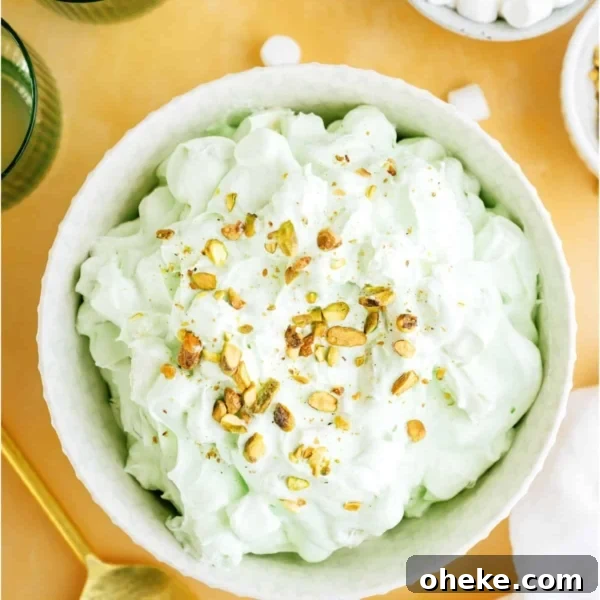 Top view of a serving bowl of 5 Minute Pistachio Salad with a small bowl of mini marshmallows off to the side.