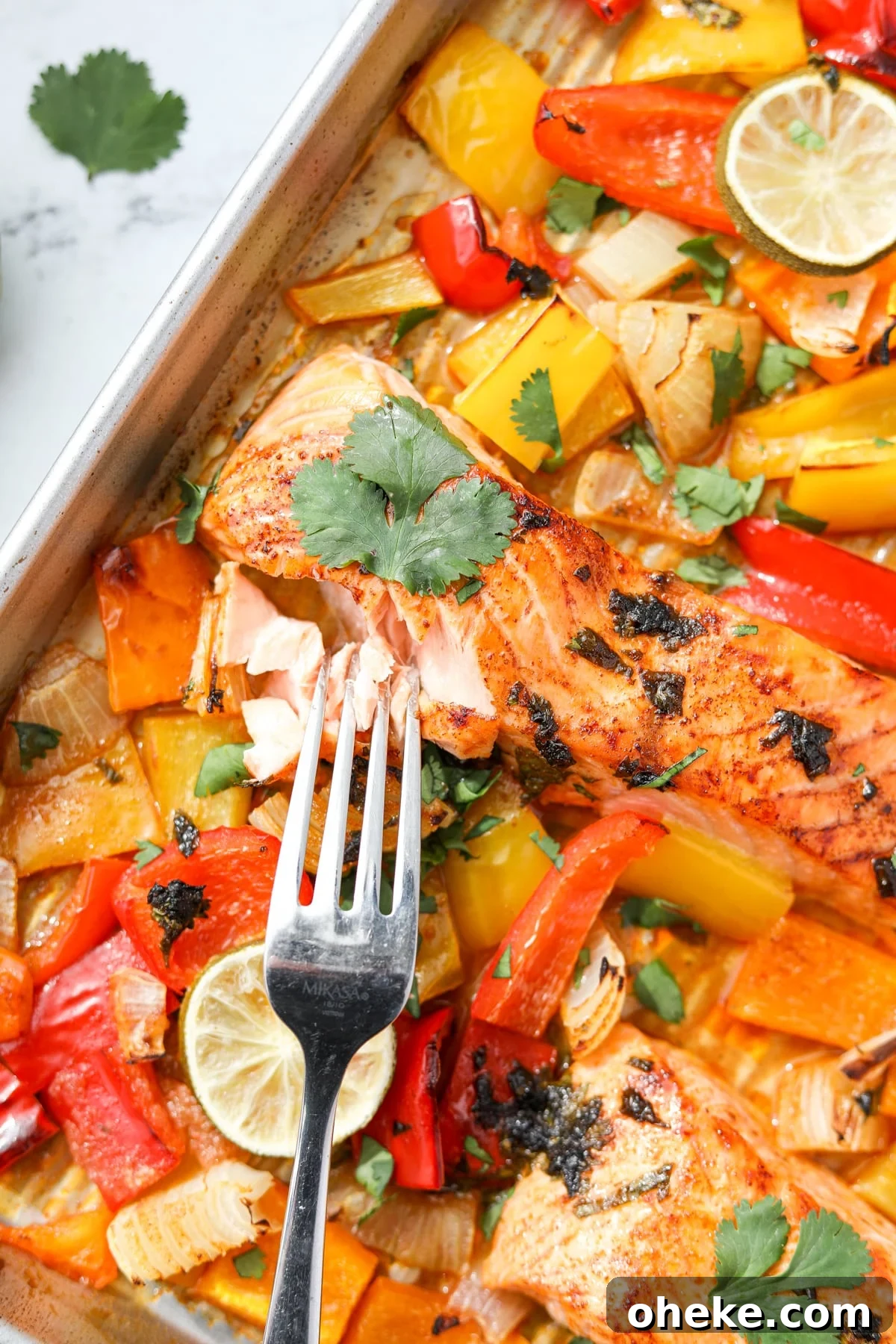 Zesty Cilantro-Lime Salmon Recipe for Quick Weeknight Dinners 2 A fork taking a portion of a salmon fillet.