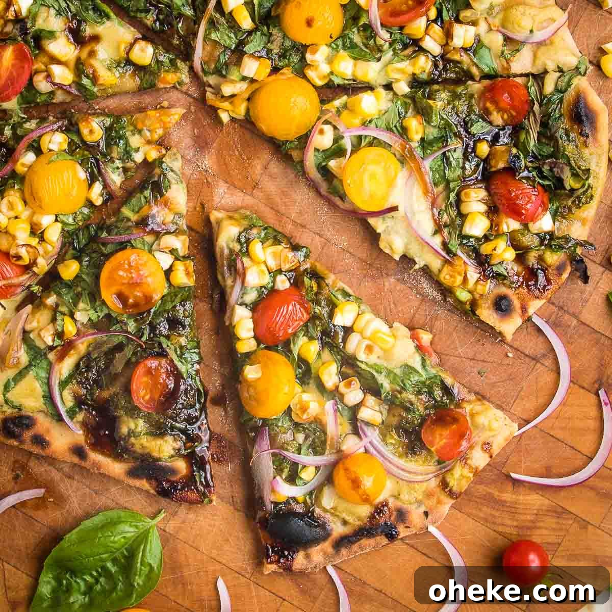 Flatbread Pizza with pesto, hummus, yellow and red tomatoes plus fresh basil and red onions.