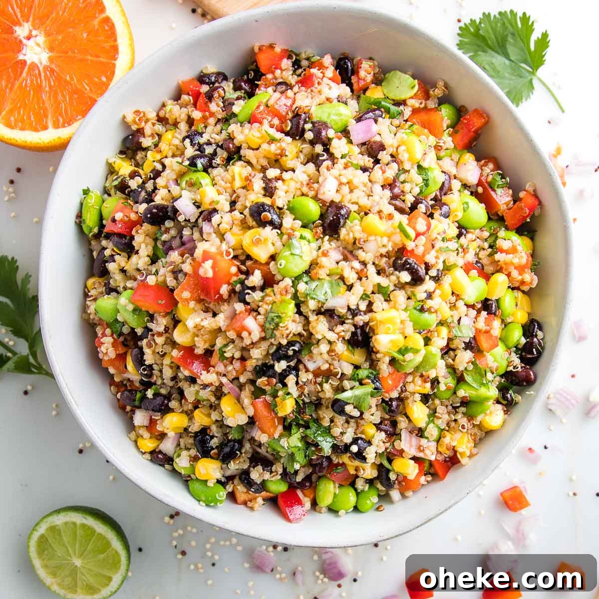 close up photo of a large white bowl filled with colorful quinoa salad