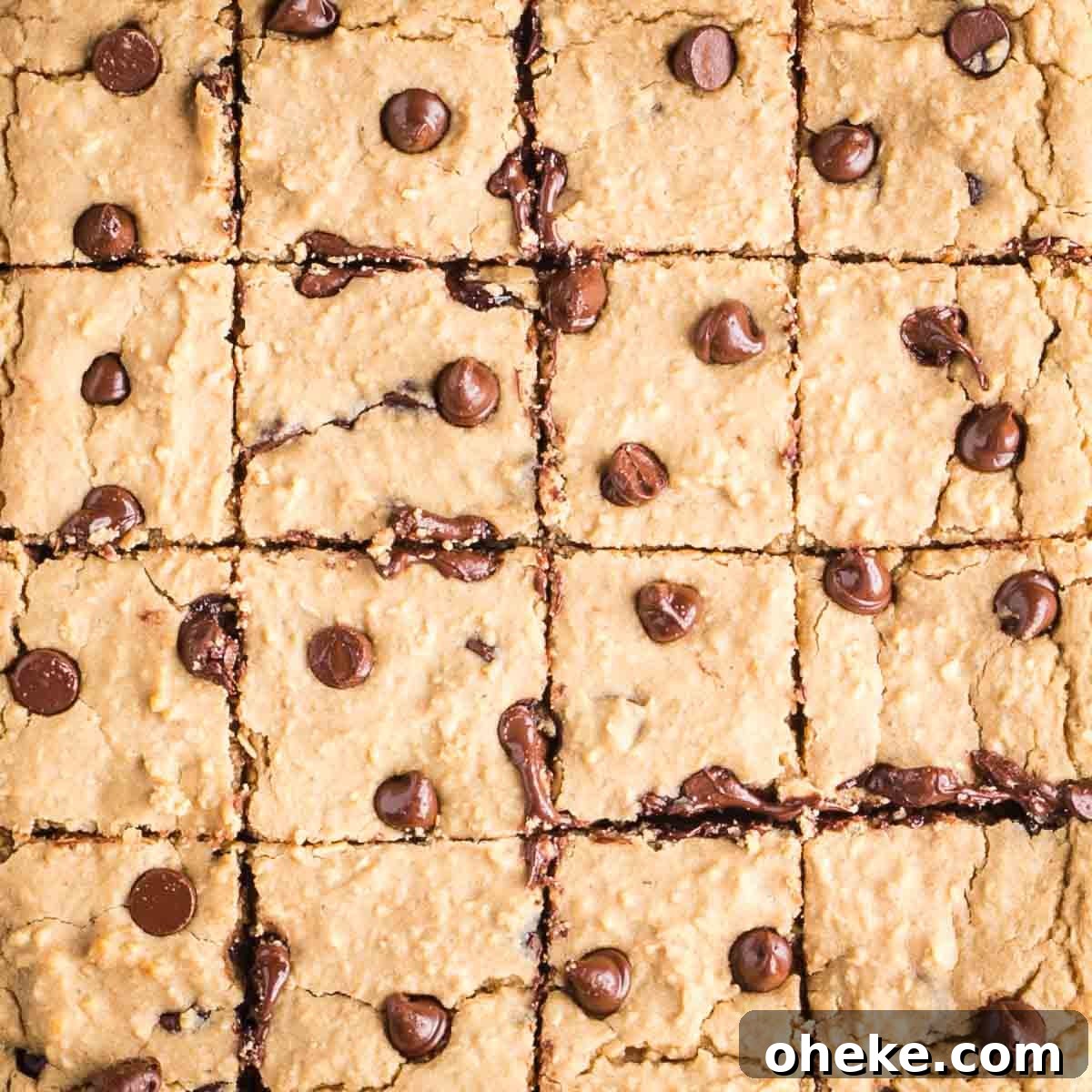 Rows of square cut blondies with chocolate chips.