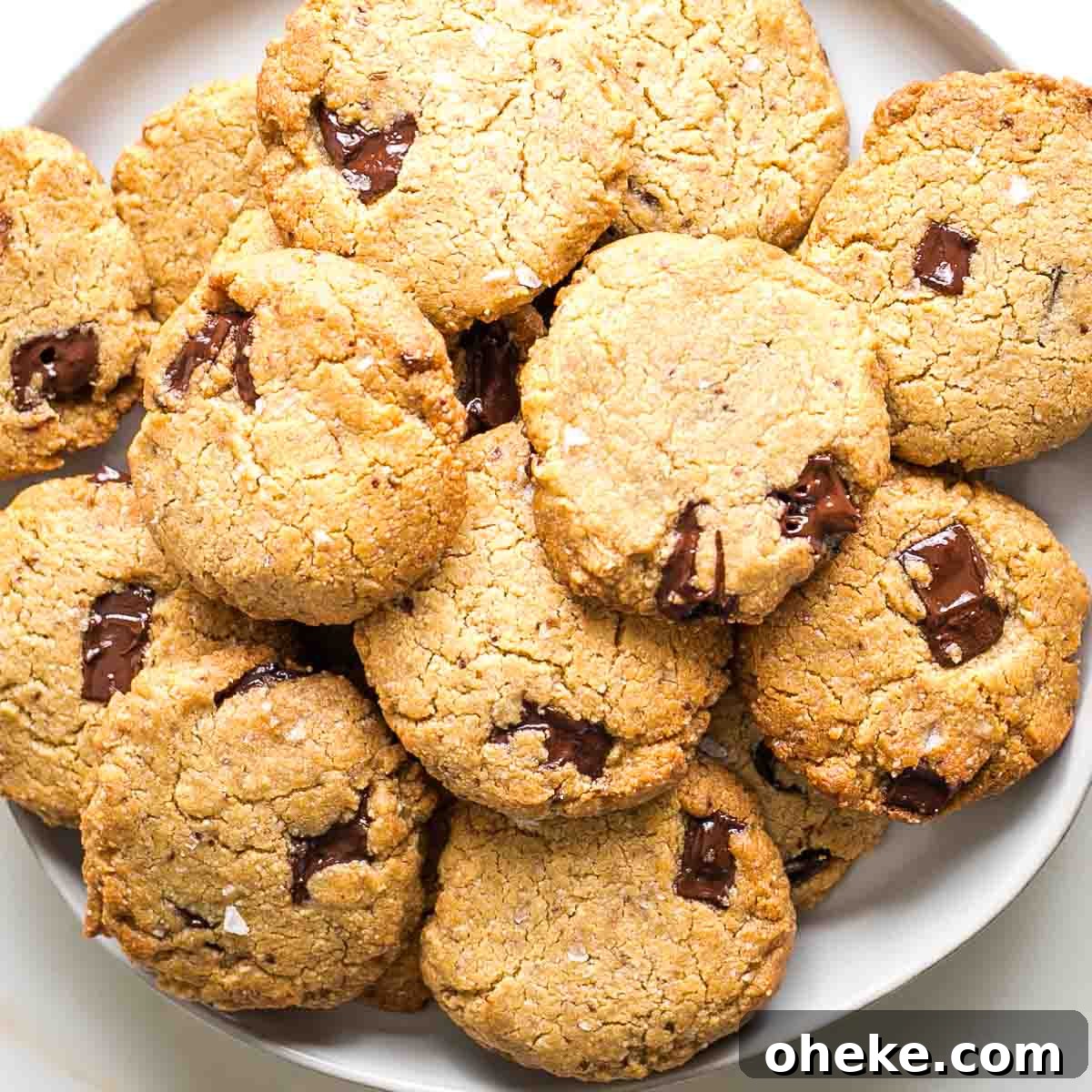Plate stacked with chocolate chunk cookies.