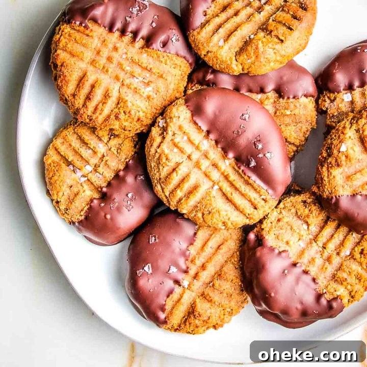Peanut butter cookies with fork marks, dipped in dark chocolate and sprinkled with flakey salt.