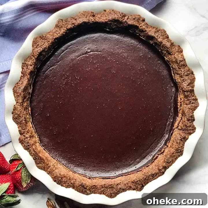 Pecan and date crust filled with chocolate pudding for a chocolate pie.