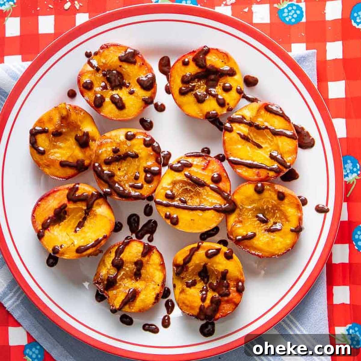 Plate of grilled peaches with a chocolate balsamic drizzle