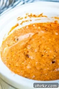 Crockpot chili cheese dip in a white slow cooker.
