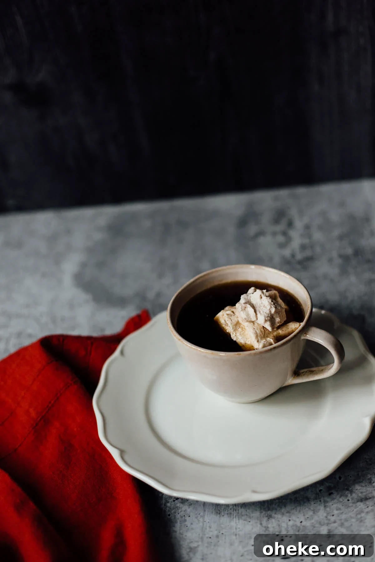 Cinnamon-Spiced Whipped Cream Recipe for Desserts 4 cinnamon whipped cream in coffee with a towel on the side