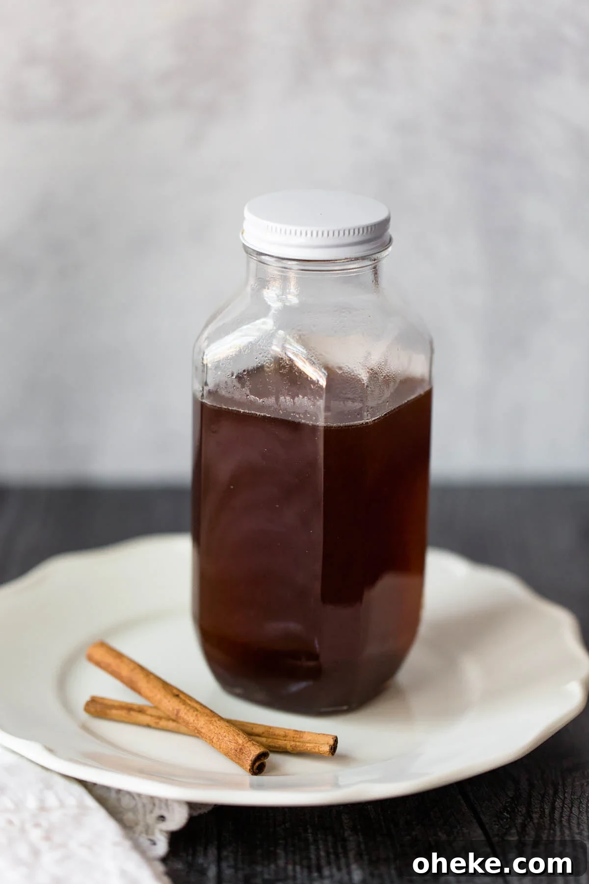 Cinnamon-Spiced Whipped Cream Recipe for Desserts 5 cinnamon simple syrup in a jar with cinnamon sticks on the side