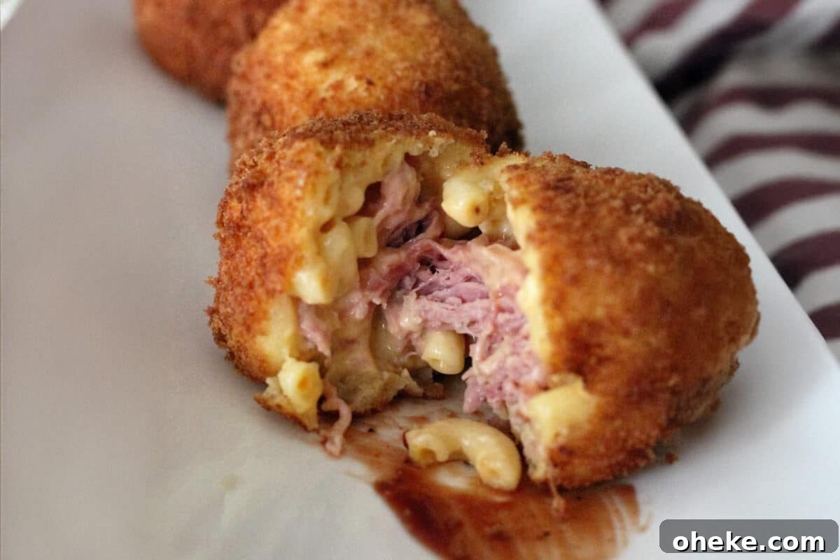 How to Store, Reheat, and Repurpose BBQ Leftovers 11 Pulled Pork Stuffed Mac and Cheese Bombs served on a white plate
