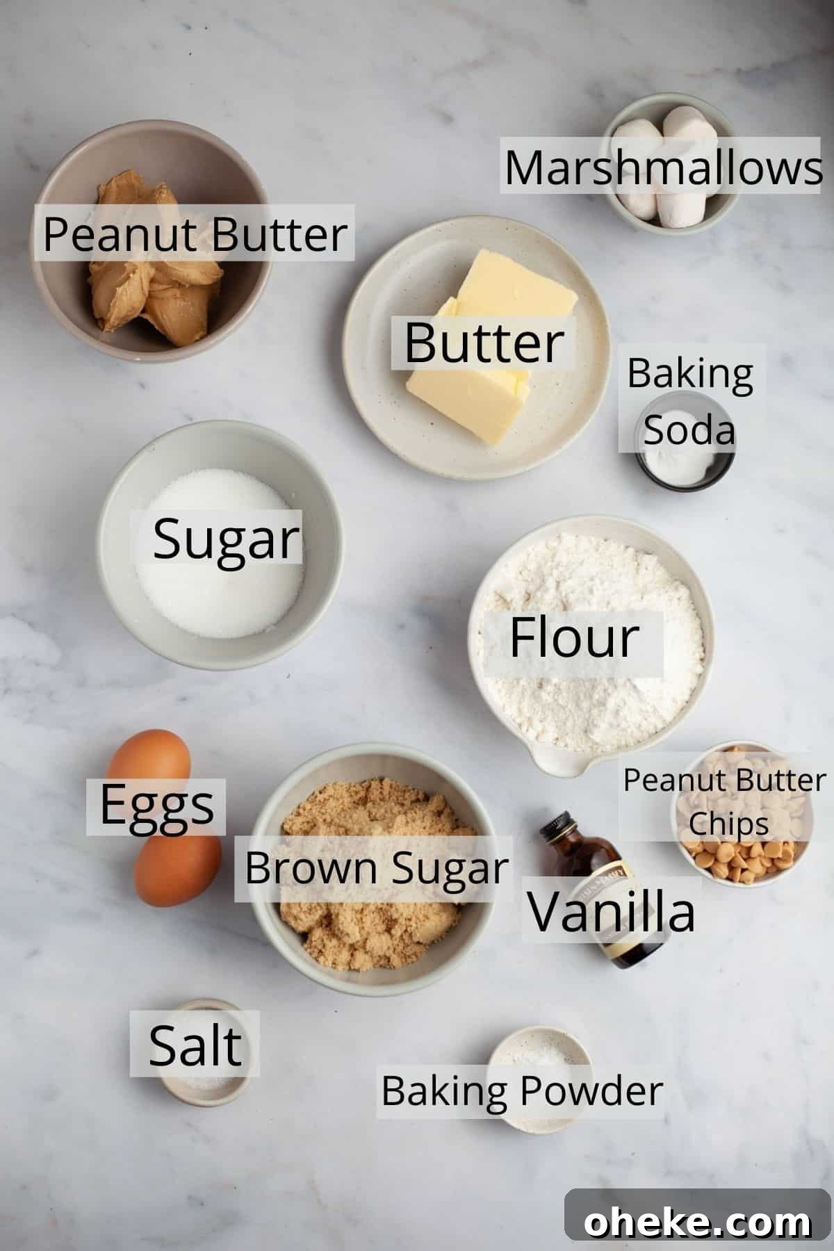 All the ingredients needed for peanut butter marshmallow cookies weighed out in small bowls.