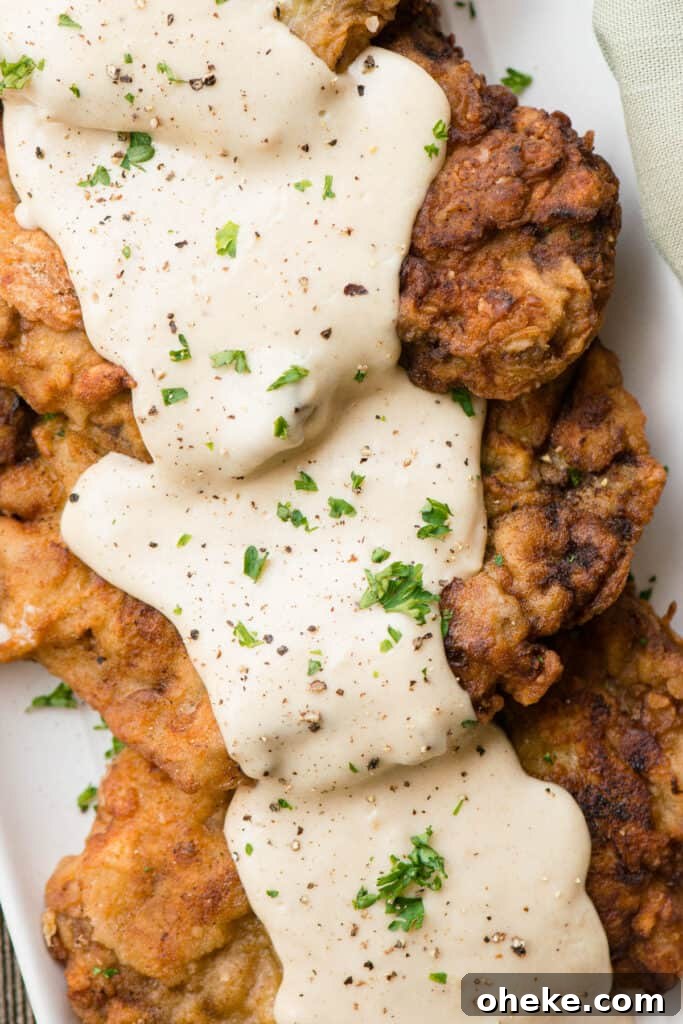Crispy Country Fried Steak Recipe with Creamy Pepper Gravy 2 Country Fried Steak covered in gravy