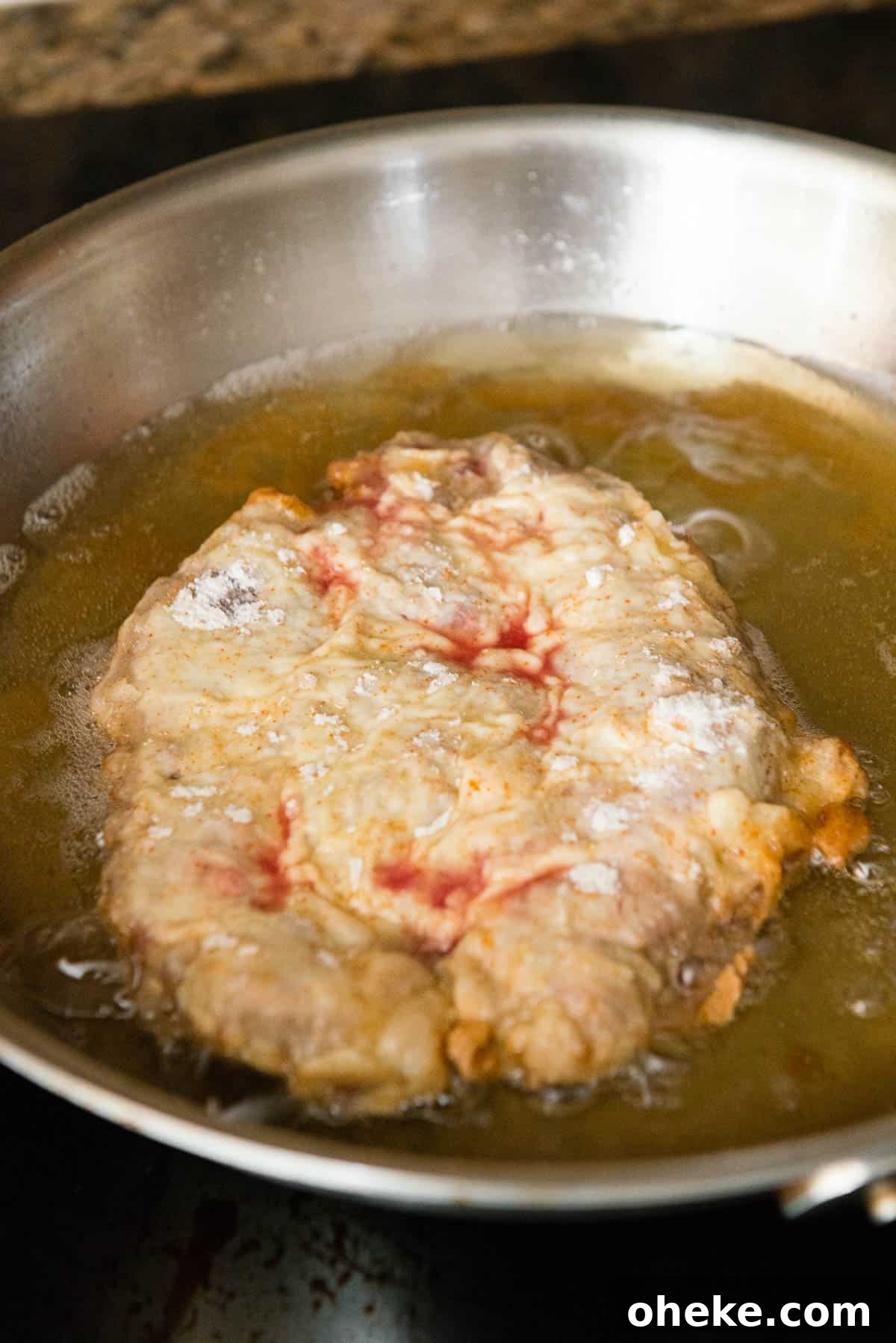 Crispy Country Fried Steak Recipe with Creamy Pepper Gravy 11 Chicken fried steak just before flipping
