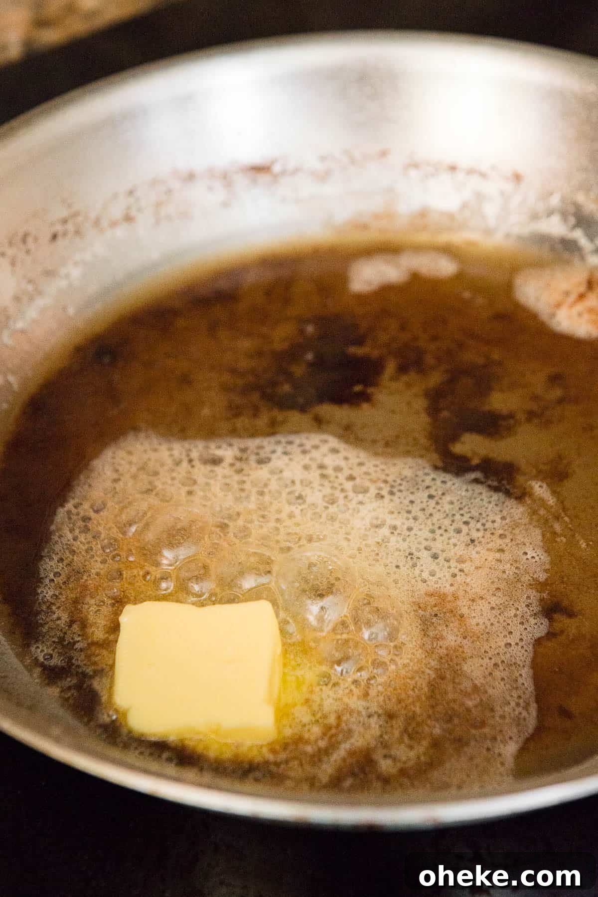 Crispy Country Fried Steak Recipe with Creamy Pepper Gravy 14 melting butter in pan drippings