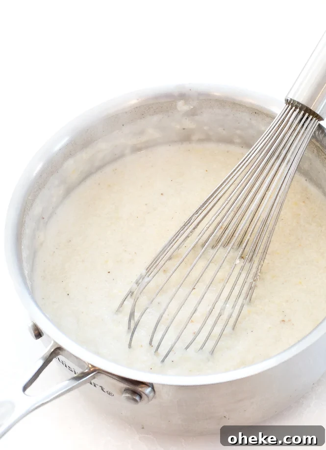 Whisking grits in a sauce pan.