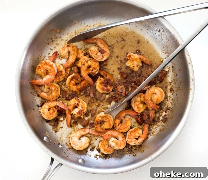 Bacon and shrimp in frying pan.