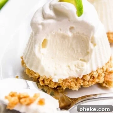 Mini No Bake Key Lime Pie on a plate topped with whipped cream and a key lime slice.