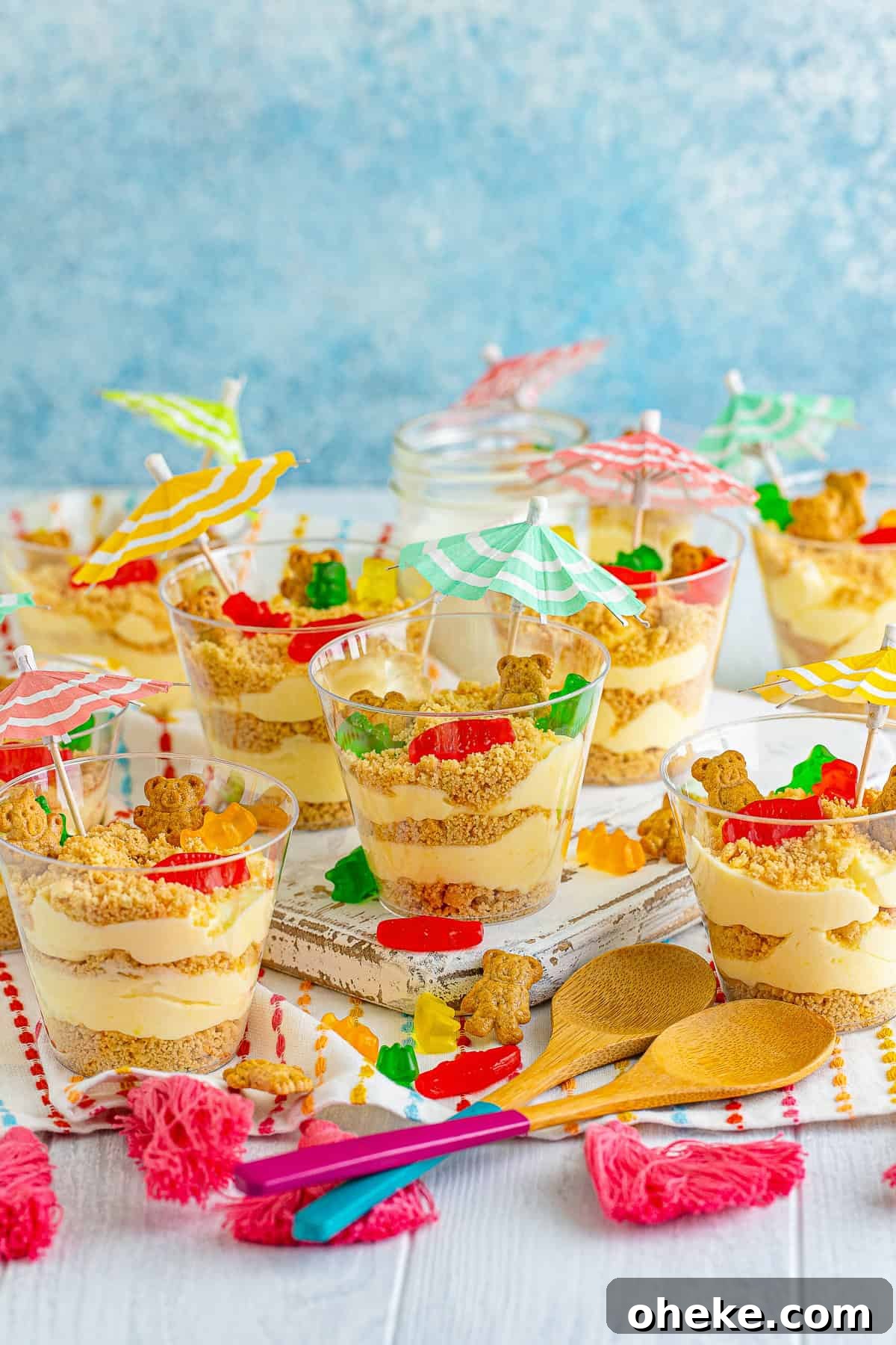 Chocolate Sand Pudding Cups Recipe for Kids' Parties 10 Sand pudding cups on a table with gummi fish and beach decorations.