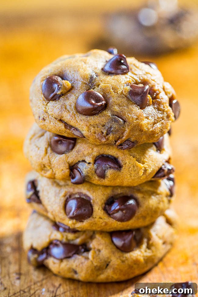 A stack of four Soft and Chewy Pumpkin Chocolate Chip Cookies. 