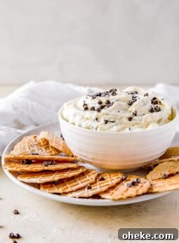 bowl of cannoli dip with mini chocolate chips on plate with pizzelle cookies