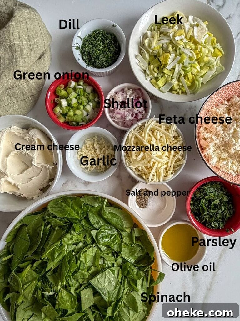 Creamy Baked Spanakopita Dip with Spinach & Feta 4 Ingredients which include: spinach, cream cheese, feta cheese, mozzarella cheese, green onions, dill, parsley, shallot, salt, pepper, olive oil, leek.