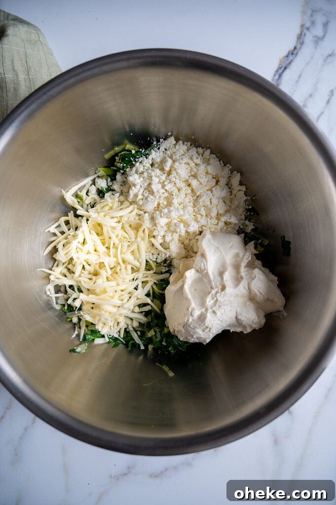 Creamy Baked Spanakopita Dip with Spinach & Feta 9 Combining the sautéed spinach with the 3 cheeses: Mozzarella, feta cheese, and cream cheese.
