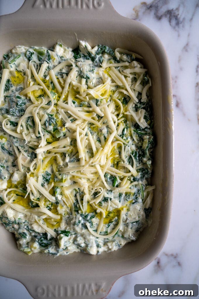 Creamy Baked Spanakopita Dip with Spinach & Feta 10 The spananakopita dip is assembled and ready to bake.
