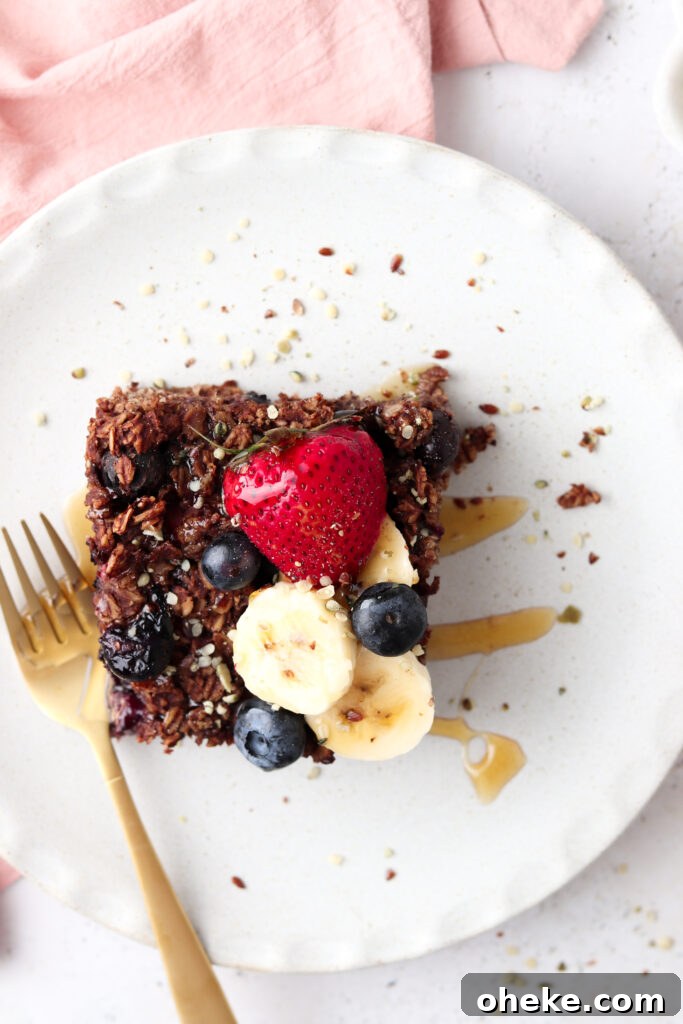 Gluten-Free Dairy-Free Chocolate Baked Oats Recipe 2 chocolate baked oats on a plate with berrries