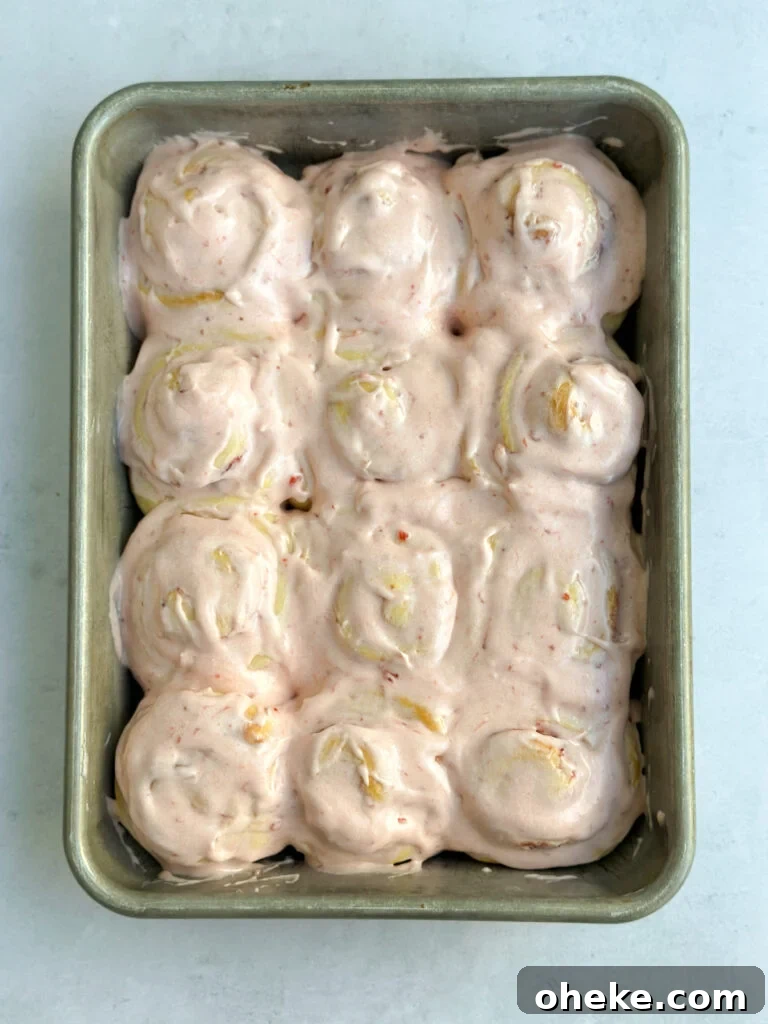 Strawberry Cinnamon Roll Recipe — Soft, Gooey Strawberry Swirls 17 strawberry cinnamon rolls all frosted.