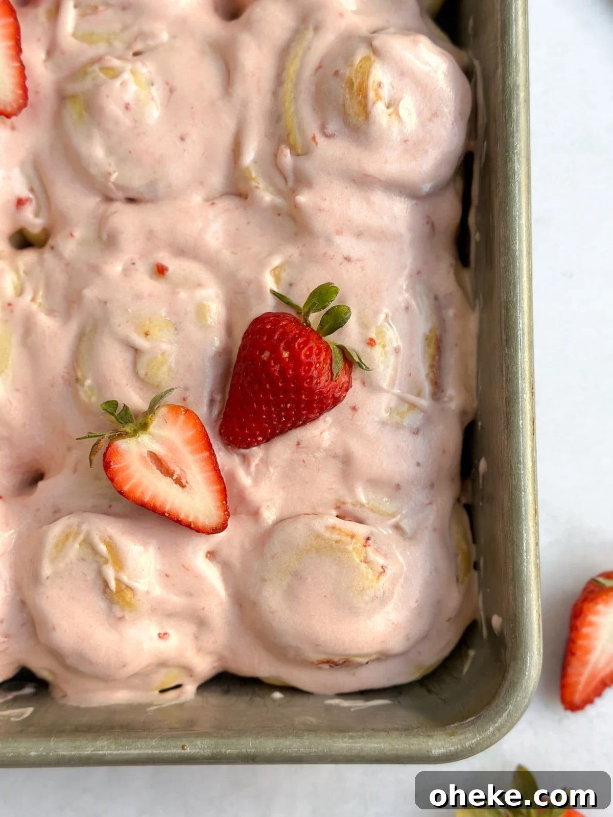 Strawberry Cinnamon Roll Recipe — Soft, Gooey Strawberry Swirls 18 a close up of the strawberry cinnamon rolls inside the pan.